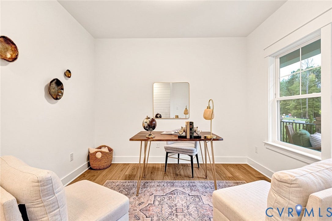 9107 Terroir Lane, Viniterra Villas, New Kent, VA 23124 Bright room featuring crisp white walls, wood-finish flooring, and a window with trim detail