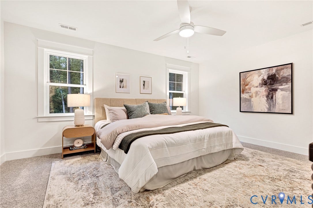 9107 Terroir Lane, Viniterra Villas, New Kent, VA 23124 Bright room featuring neutral wall color, plush carpeting, double-hung windows with exterior trim, and a white ceiling fan with an integrated light fixture