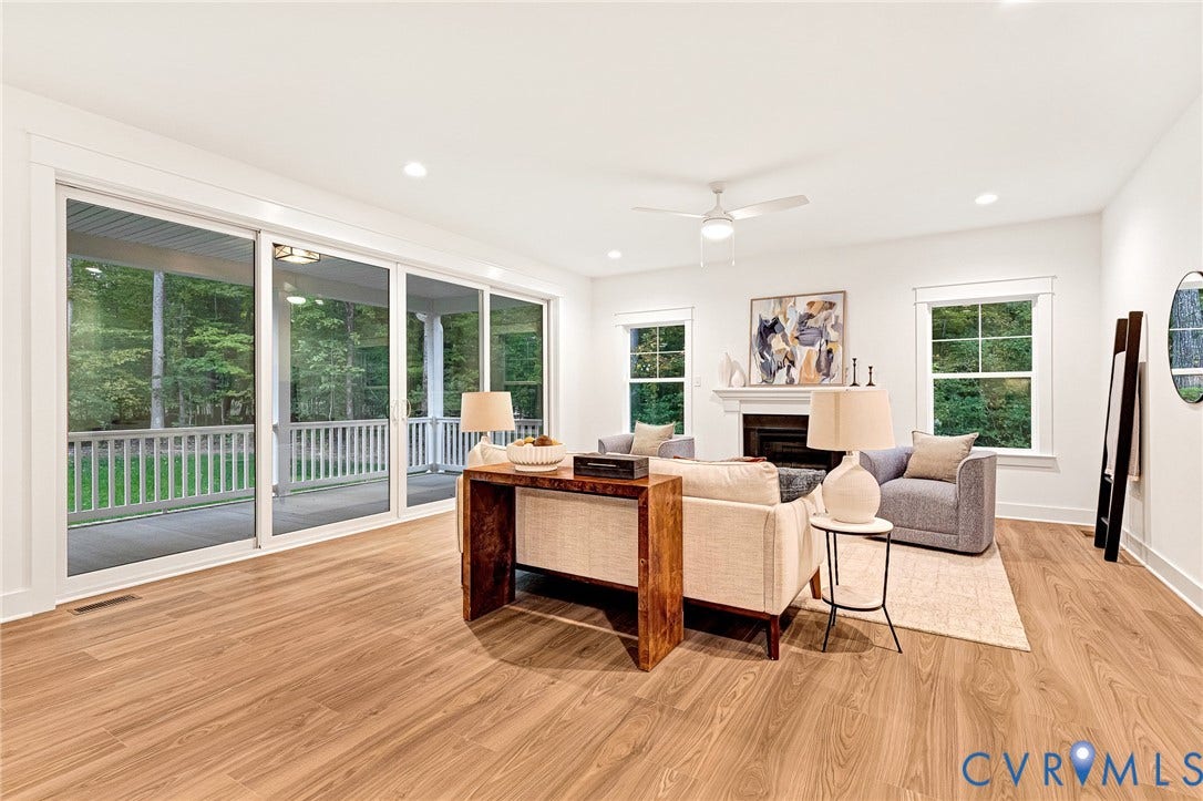9107 Terroir Lane, Viniterra Villas, New Kent, VA 23124 Living room featuring wood-finish flooring, a fireplace with a mantel, recessed lighting, a ceiling fan, and large sliding glass doors