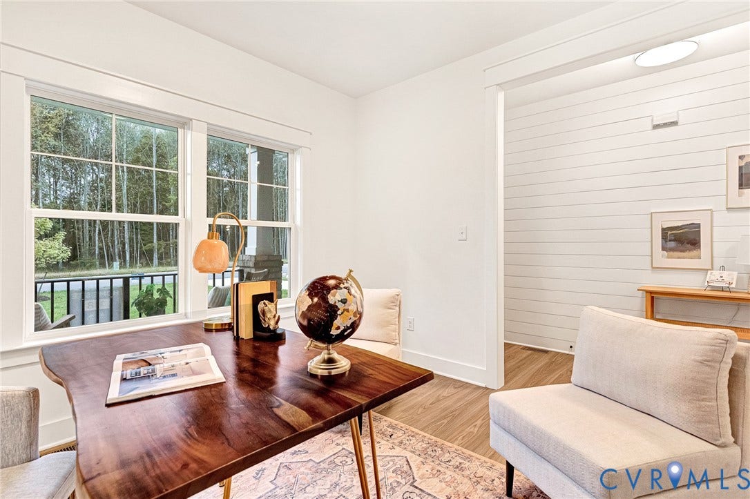 9107 Terroir Lane, Viniterra Villas, New Kent, VA 23124 Bright room featuring large multi-pane windows, plank-style wall paneling, and wood-finish flooring