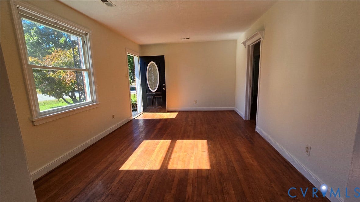 38 Eastlake Drive, Sandston, Sandston, VA 23150 Interior space featuring wood-finish flooring, a large window, and an exterior door with an oval glass insert