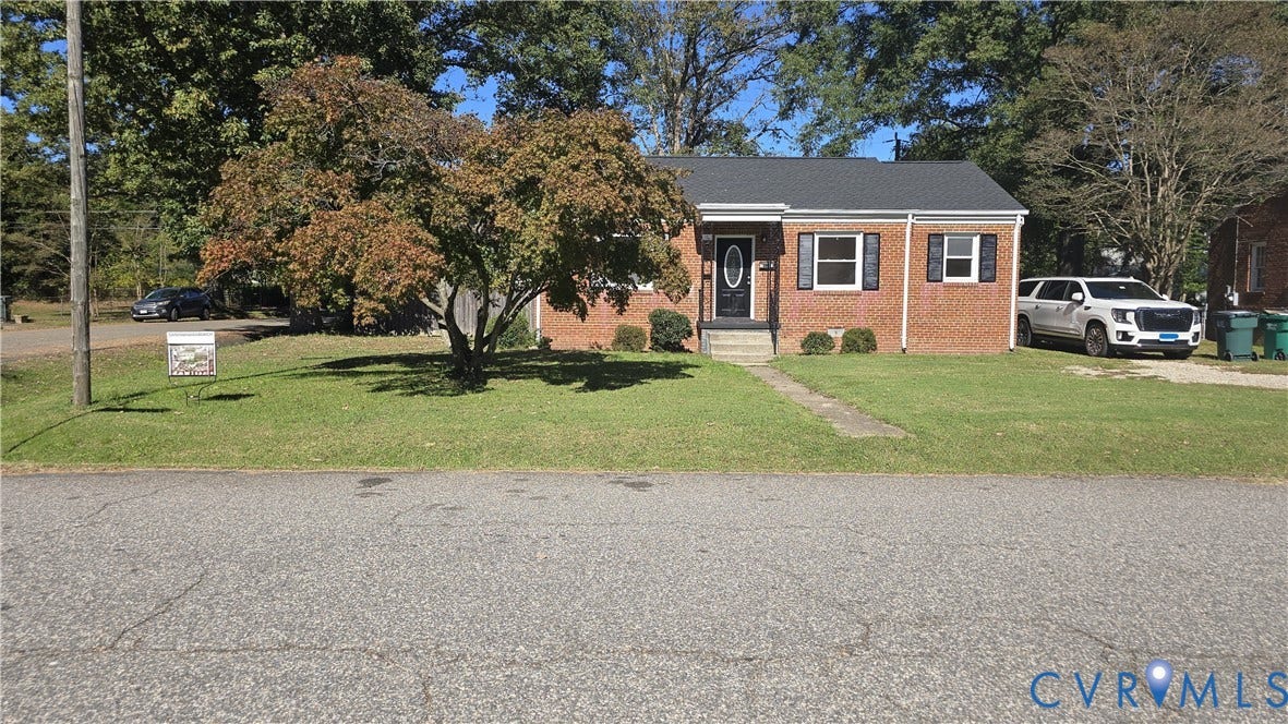 38 Eastlake Drive, Sandston, Sandston, VA 23150 Single-story brick exterior featuring a dark shingle roof, decorative exterior shutters, and a covered front entry