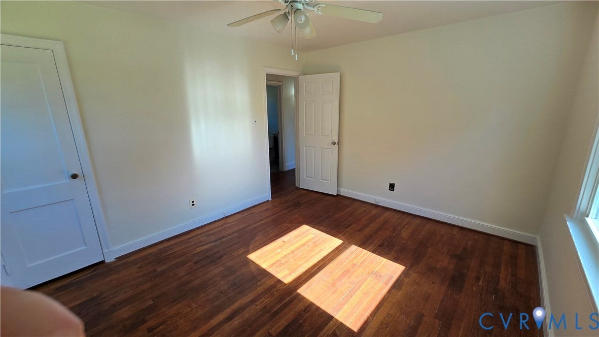 38 Eastlake Drive, Sandston, Sandston, VA 23150 Interior room featuring wood-finish flooring, white paneled doors, and a ceiling-mounted light fixture with fan blades
