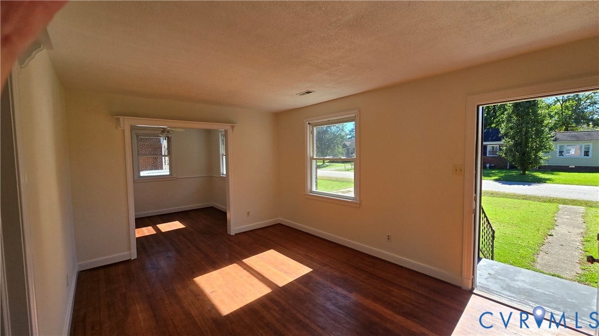 38 Eastlake Drive, Sandston, Sandston, VA 23150 Interior featuring wood-finish flooring, white wall trim, and multiple windows providing natural light