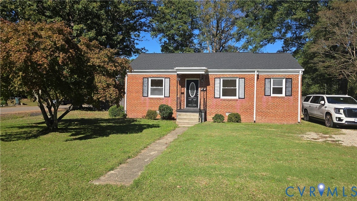 38 Eastlake Drive, Sandston, Sandston, VA 23150 Single-story brick exterior featuring a shingled gable roof, shuttered windows, and a covered front entry