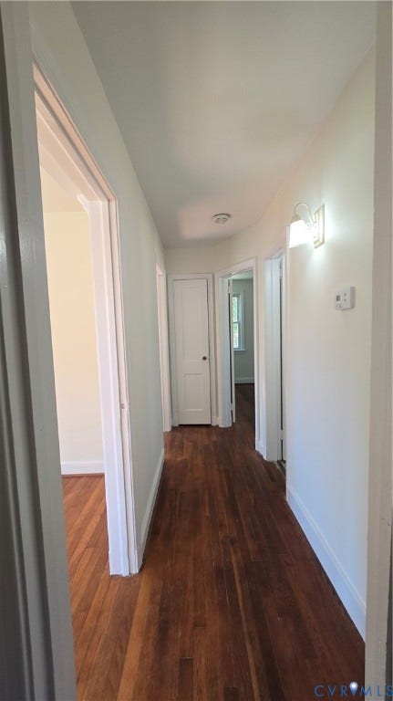38 Eastlake Drive, Sandston, Sandston, VA 23150 Interior hallway featuring wood-finish flooring, white paneled interior doors, and wall-mounted light fixtures