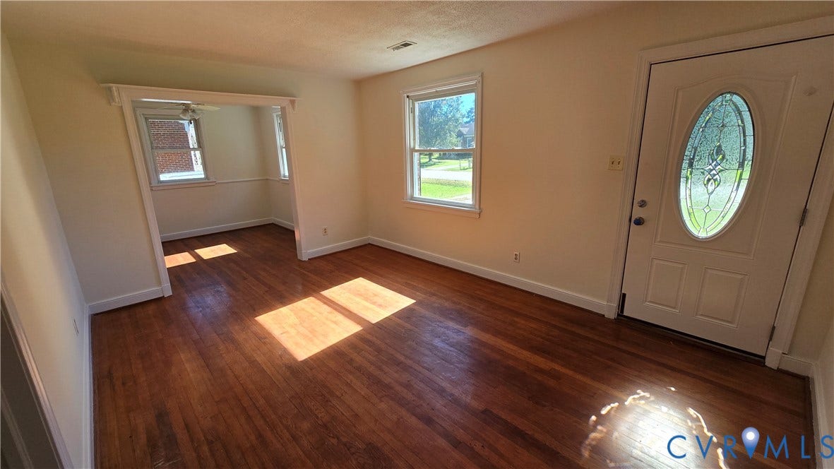 38 Eastlake Drive, Sandston, Sandston, VA 23150 Interior space featuring wood-finish flooring, white wall trim, and an exterior door with an oval glass inset