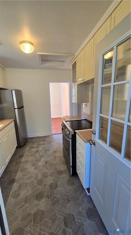 38 Eastlake Drive, Sandston, Sandston, VA 23150 Kitchen featuring hexagon tile flooring, stainless steel range, stainless steel refrigerator, white cabinetry, and a glass-paneled exterior door