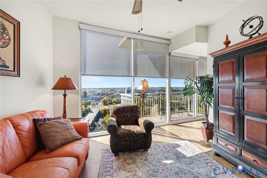 301 Virginia Street, #U1712, Richmond, VA 23219 Floor-to-ceiling windows, wood-finish flooring, and access to a railed balcony