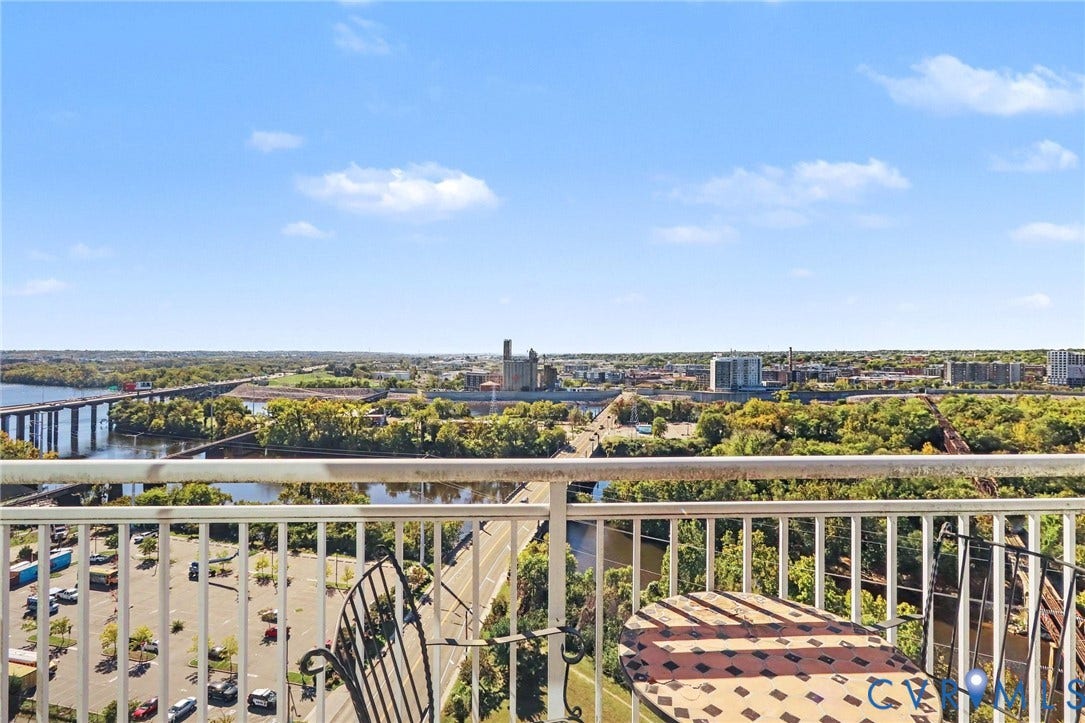 301 Virginia Street, #U1712, Richmond, VA 23219 Elevated balcony with a metal railing overlooking expansive terrain including a river, bridge, and urban landscape