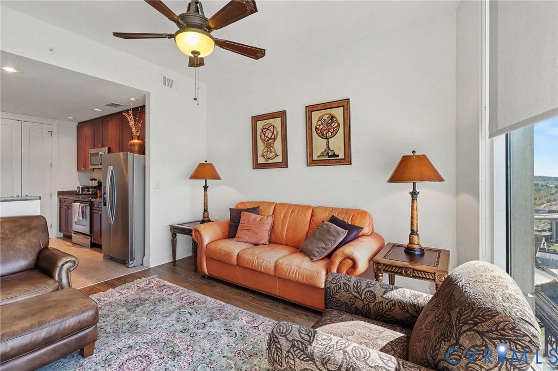 301 Virginia Street, #U1712, Richmond, VA 23219 Open-concept living space with wood-finish flooring, ceiling fan, and floor-to-ceiling windows