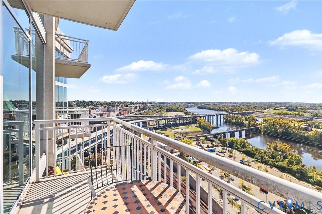 301 Virginia Street, #U1712, Richmond, VA 23219 Private balcony with white metal railing, floor-to-ceiling glass exterior wall, and metal facade detailing