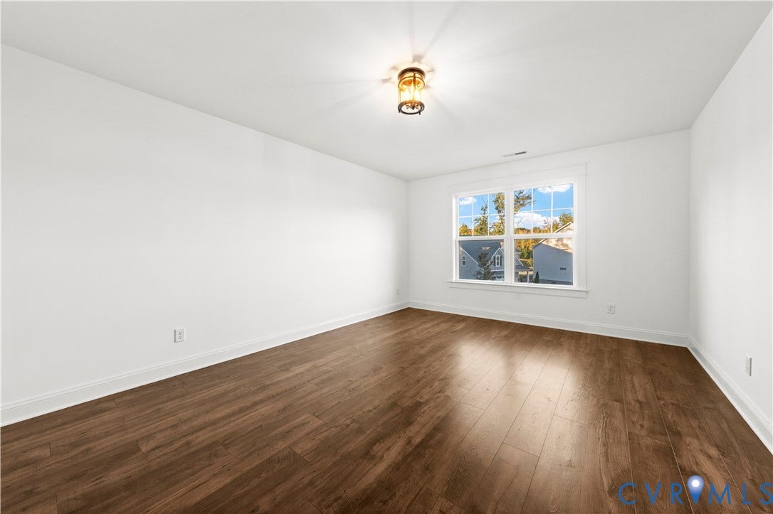 2613 Lilybank Place, NewMarket At RounTrey, Midlothian, VA 23112 Room featuring wood-finish flooring, a multi-pane window, and a central flush-mount light fixture