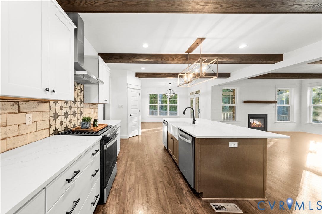 2613 Lilybank Place, NewMarket At RounTrey, Midlothian, VA 23112 Kitchen featuring white shaker-style cabinetry, quartz countertops, a patterned tile backsplash, wood-finish flooring, and exposed timber ceiling beams