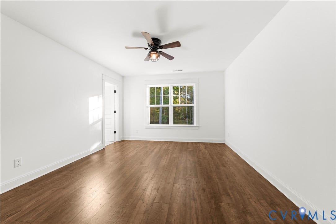 2613 Lilybank Place, NewMarket At RounTrey, Midlothian, VA 23112 Room featuring wood-finish flooring, a multi-pane window, and a ceiling fan with integrated lighting