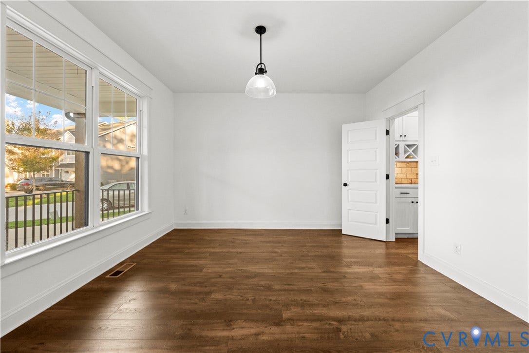 2613 Lilybank Place, NewMarket At RounTrey, Midlothian, VA 23112 Wood-finish flooring, large multi-pane windows, five-panel interior door, and a single-pendant light fixture