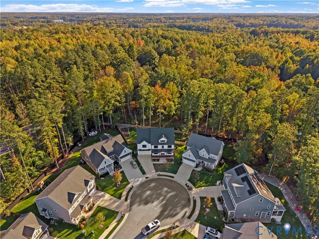 2613 Lilybank Place, NewMarket At RounTrey, Midlothian, VA 23112 Aerial perspective of a suburban cul-de-sac featuring multi-story residential dwellings, concrete driveways, and surrounding dense woodland