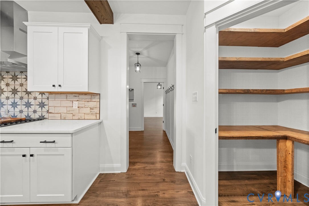 2613 Lilybank Place, NewMarket At RounTrey, Midlothian, VA 23112 Kitchen featuring white cabinetry, quartz countertops, patterned tile backsplash, wood-finish flooring, and a walk-in pantry with wood shelving