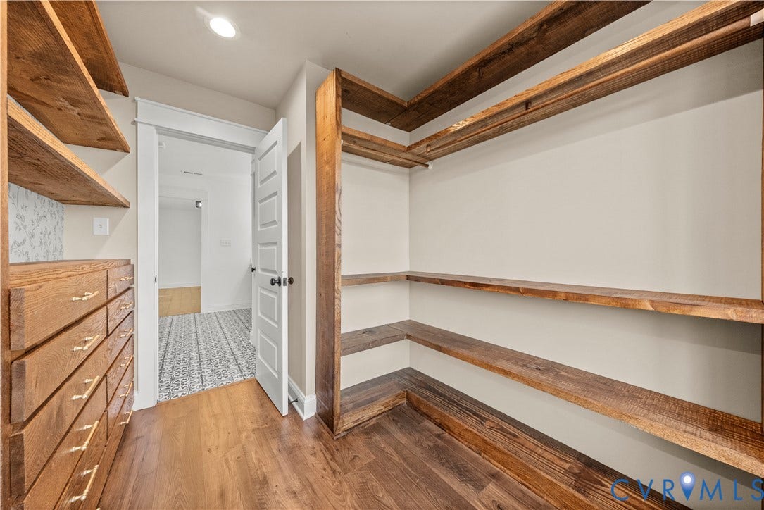 2613 Lilybank Place, NewMarket At RounTrey, Midlothian, VA 23112 Custom reach-in closet featuring natural wood-finish shelving, built-in drawer units with metallic hardware, and wood-finish flooring