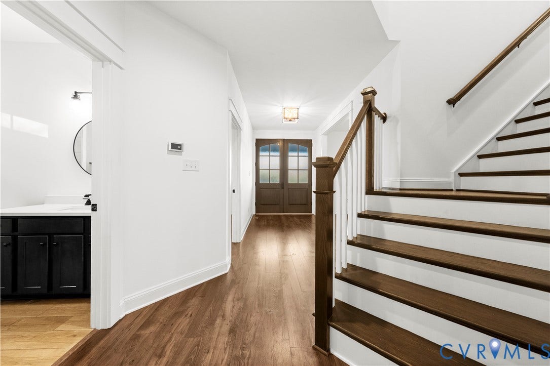 2613 Lilybank Place, NewMarket At RounTrey, Midlothian, VA 23112 Entry foyer featuring double glass-paneled front doors, wood-finish flooring, and a staircase with stained wood treads and white balusters