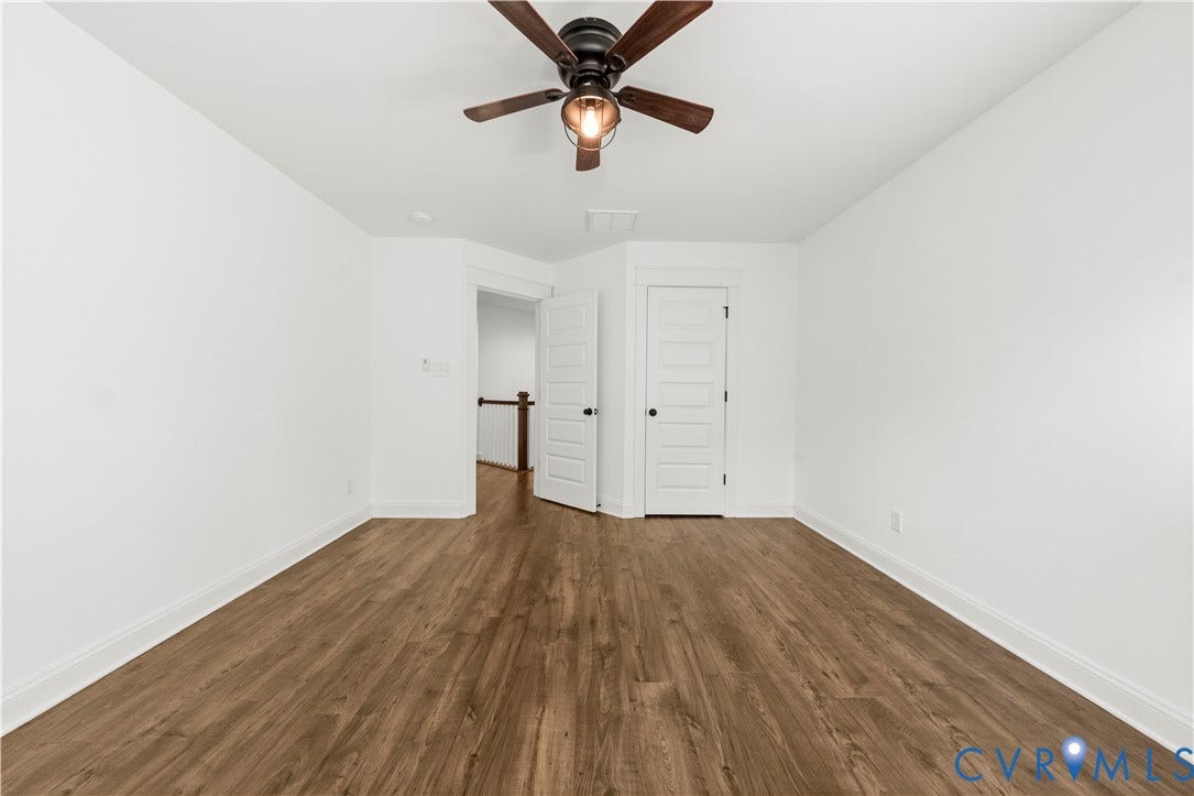 2613 Lilybank Place, NewMarket At RounTrey, Midlothian, VA 23112 Interior room featuring wood-finish flooring, a multi-blade ceiling fan with integrated lighting, and white five-panel interior doors