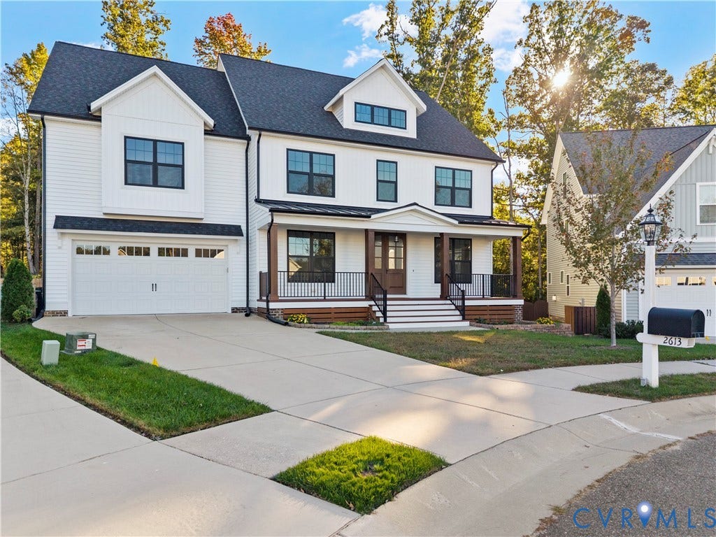 2613 Lilybank Place, NewMarket At RounTrey, Midlothian, VA 23112 Multi-level exterior featuring white siding, a metal-accented front porch with dark railings, a steeply pitched roof, and an attached two-car garage