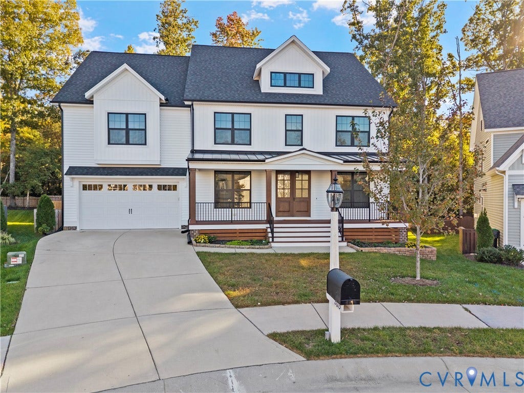 2613 Lilybank Place, NewMarket At RounTrey, Midlothian, VA 23112 Two-story residence featuring a white vertical and horizontal siding exterior, dual-gabled roofline, metal porch awning, iron railings, and a concrete driveway