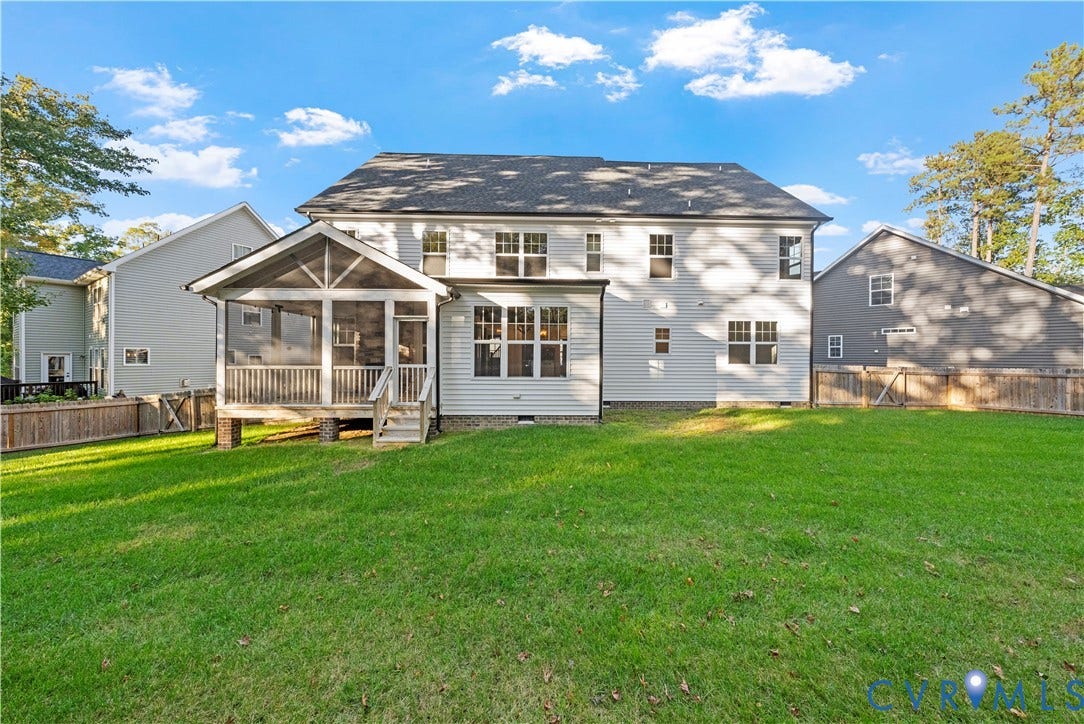 2613 Lilybank Place, NewMarket At RounTrey, Midlothian, VA 23112 Rear exterior featuring light-toned horizontal siding, a covered screened-in porch with wood-style railings, a multi-paneled roof structure, and a fenced backyard with a manicured lawn
