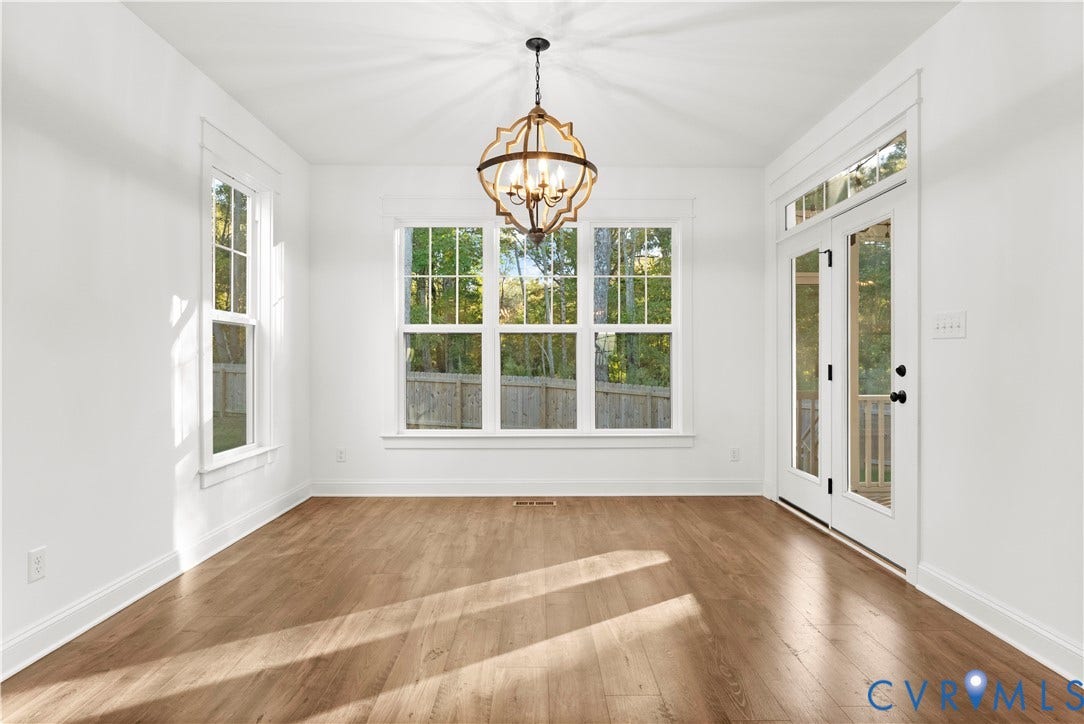 2613 Lilybank Place, NewMarket At RounTrey, Midlothian, VA 23112 Sun-filled interior featuring wood-finish flooring, a decorative metal-frame chandelier, large multi-pane windows, and double glass-panel doors with transom window