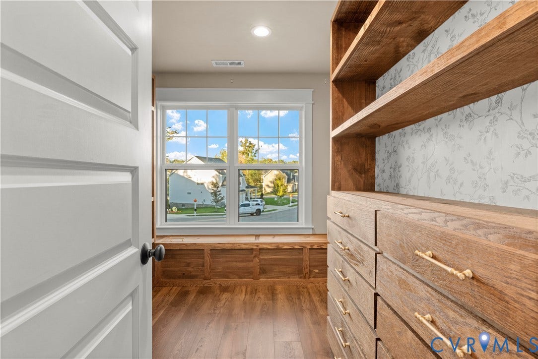 2613 Lilybank Place, NewMarket At RounTrey, Midlothian, VA 23112 Built-in wooden cabinetry featuring open shelving and soft-close drawers with brass-finish hardware, wood-finish flooring, and a custom window seat