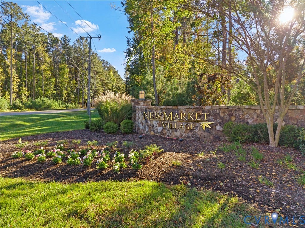 2613 Lilybank Place, NewMarket At RounTrey, Midlothian, VA 23112 Stone monument signage featuring dimensional gold-toned lettering, set within a landscaped community entrance with mature trees and groomed shrubbery