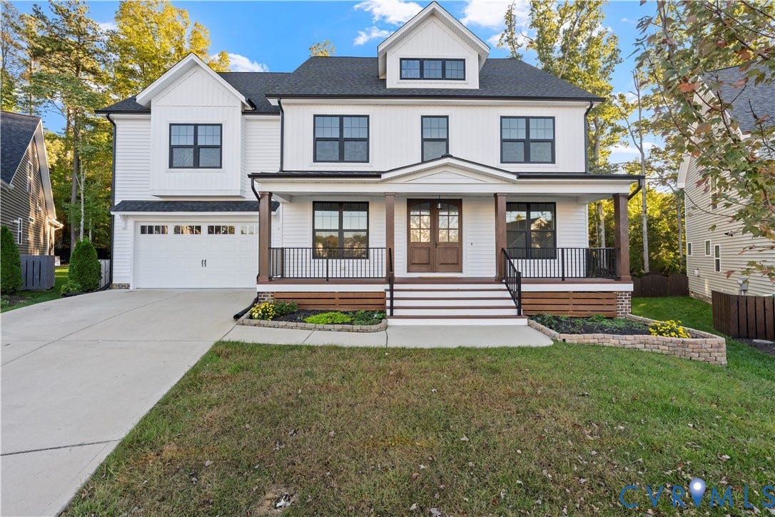 2613 Lilybank Place, NewMarket At RounTrey, Midlothian, VA 23112 Two-story exterior featuring white horizontal siding, dark-framed windows, a covered front porch with timber-finished columns, a double-door entrance, and an attached two-car garage