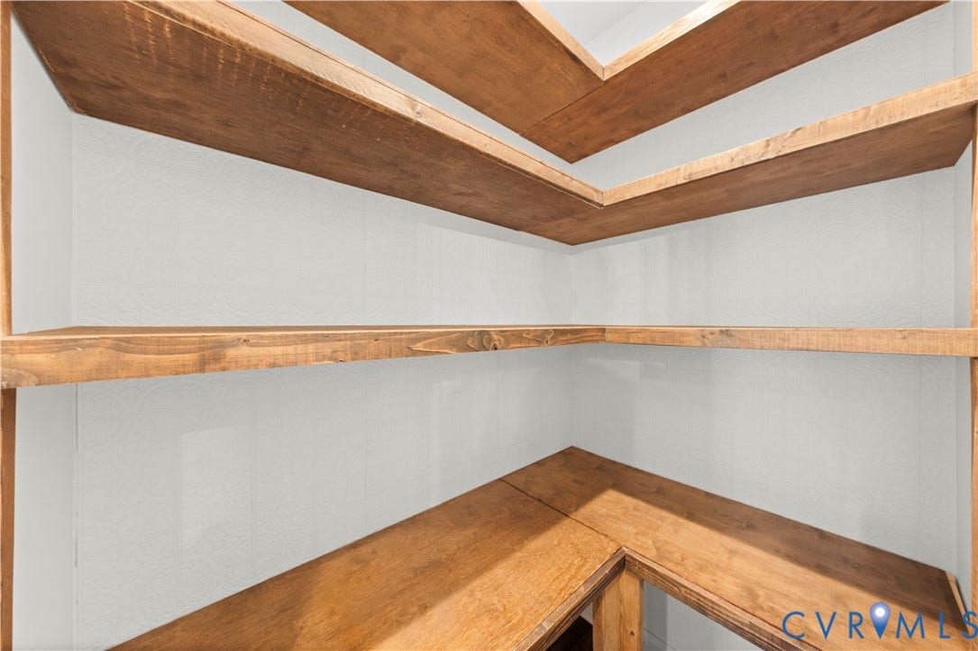 2613 Lilybank Place, NewMarket At RounTrey, Midlothian, VA 23112 Built-in corner shelving featuring stained wood-finish surfaces and neutral wall paneling