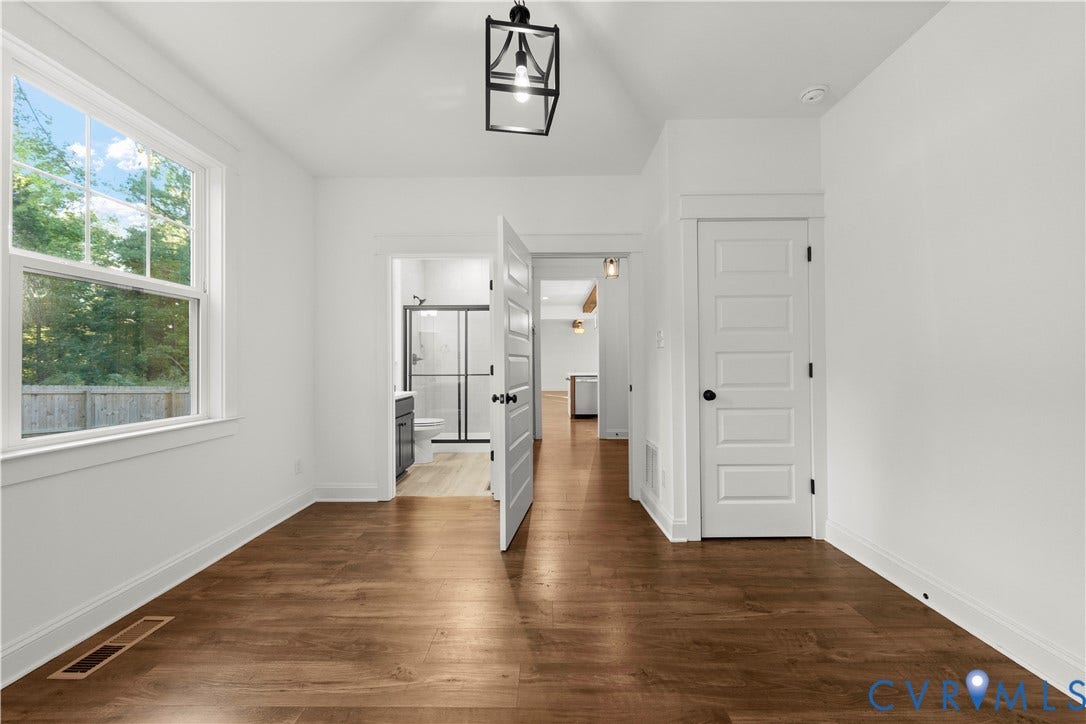 2613 Lilybank Place, NewMarket At RounTrey, Midlothian, VA 23112 Vaulted ceiling with a geometric pendant light, wood-finish flooring, and single-hung window featuring a grid pattern
