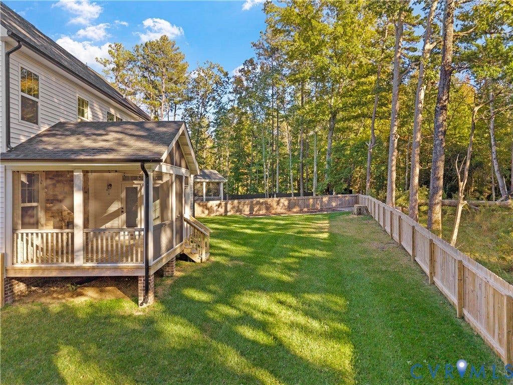 2613 Lilybank Place, NewMarket At RounTrey, Midlothian, VA 23112 Screened porch featuring a shingle roof and brick foundation piers, paired with a fenced backyard, manicured lawn, and mature trees