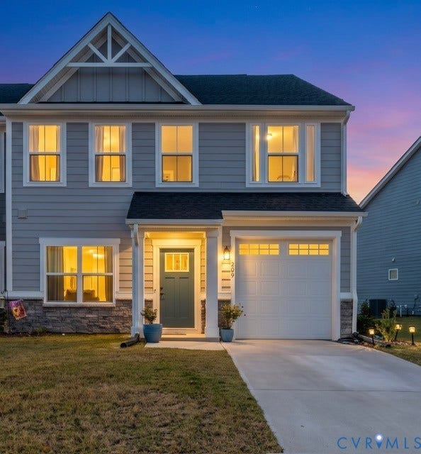 209 Timber Passage Trail, #12A, Williamsburg, VA 23185 Two-story exterior featuring gray lap siding, stone veneer base, a gabled roofline with decorative trim, and a concrete driveway