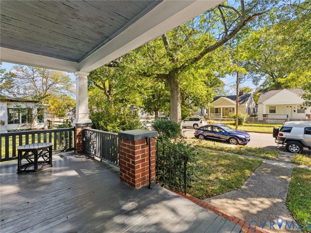 2305 Halifax Avenue, Oak Grove, Sandston, VA 23224 Covered front porch featuring painted wood decking, a solid column, and brick masonry pillars with black wrought-iron railings