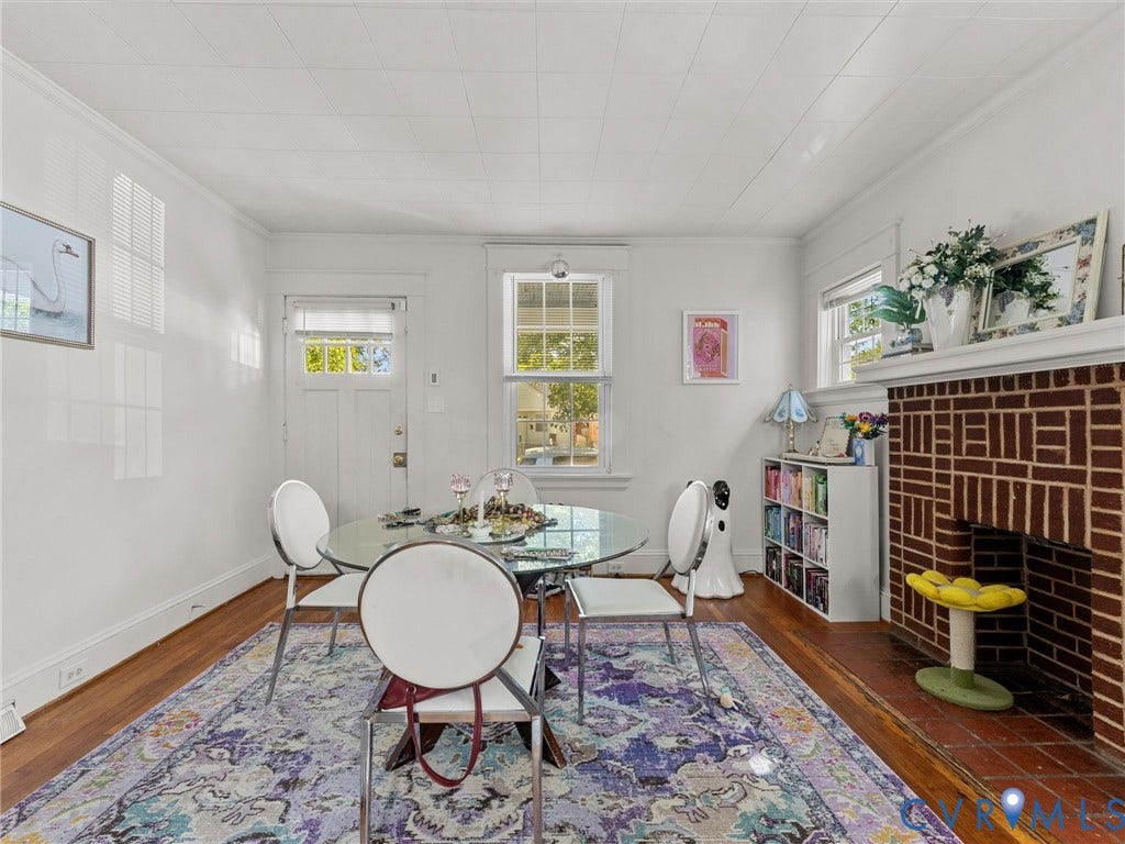2305 Halifax Avenue, Oak Grove, Sandston, VA 23224 Exposed brick fireplace with a custom mantel, wood-finish flooring, and multi-pane windows