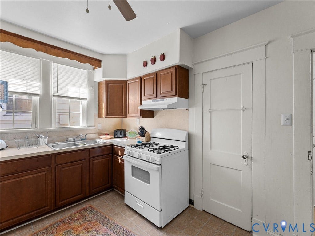 2305 Halifax Avenue, Oak Grove, Sandston, VA 23224 Kitchen featuring stained wood cabinetry, white gas range with integrated vent hood, stainless steel dual-basin sink, and multi-pane windows