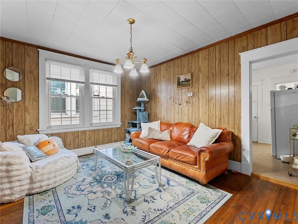 2305 Halifax Avenue, Oak Grove, Sandston, VA 23224 Wood-paneled walls, hardwood flooring, multi-pane windows, and a multi-arm chandelier