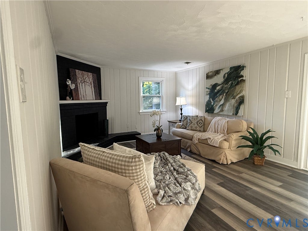 533 Williamsdale Drive, Midlothian, VA 23235 Vertical paneling, wood-finish flooring, and a fireplace with a black-finish mantel and hearth