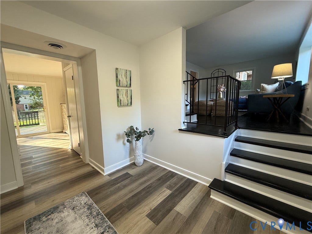 533 Williamsdale Drive, Midlothian, VA 23235 Interior featuring wood-finish flooring, a tiered floor plan with staircase, and wrought iron balustrade