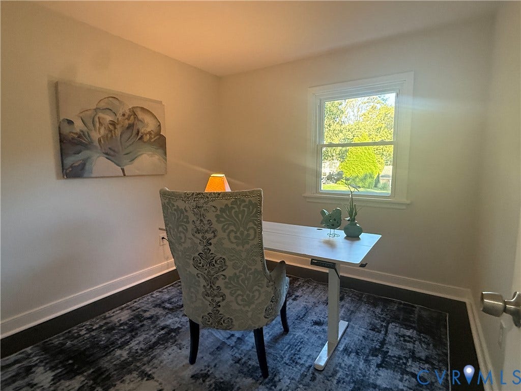 533 Williamsdale Drive, Midlothian, VA 23235 Neutral interior space featuring wood-finish flooring, crisp neutral wall paint, and a double-hung window with decorative casing