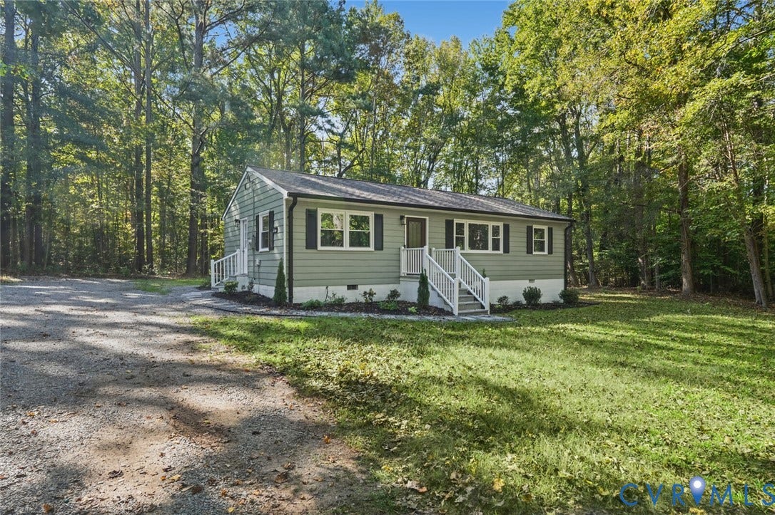 15227 Horseshoe Bridge Road, Hanover, VA 23047 Single-story home featuring sage green siding, contrasting dark shutters, multi-pane windows, elevated white-railed entry stairs, and a gravel driveway