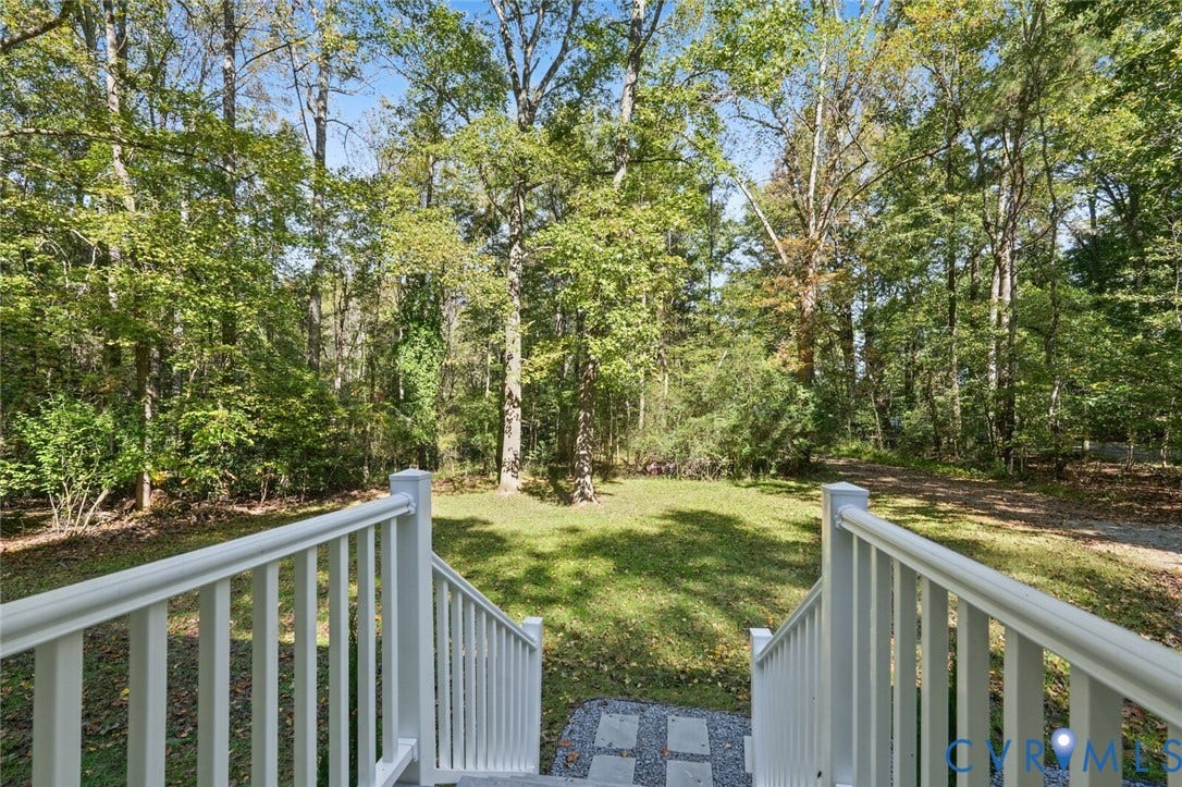 15227 Horseshoe Bridge Road, Hanover, VA 23047 White balustrade staircase, expansive grass lawn, mature tree canopy, and stone paver walkway