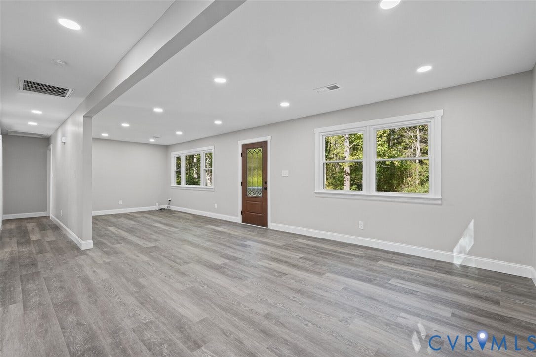 15227 Horseshoe Bridge Road, Hanover, VA 23047 Open interior space featuring wood-finish flooring, recessed lighting, multi-pane windows, and a wood entry door with glass insert