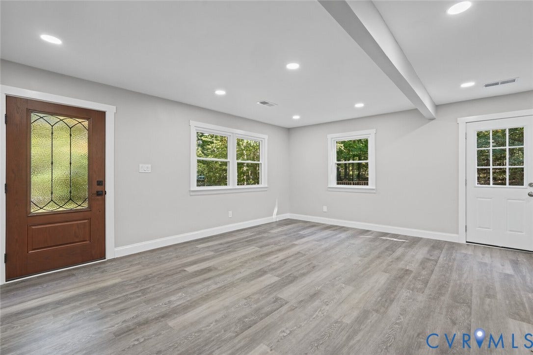 15227 Horseshoe Bridge Road, Hanover, VA 23047 Interior space featuring wood-finish flooring, recessed lighting, a decorative glass-panel entry door, and a white multi-lite exterior door