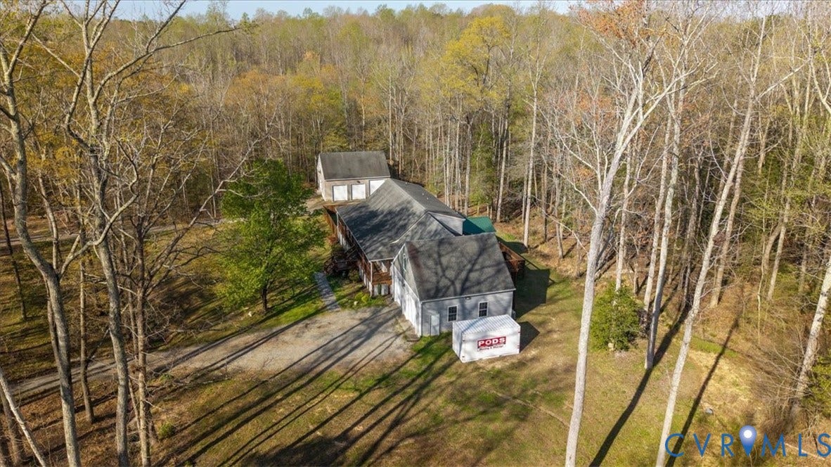 7040 Old Roxbury Road, Average, New Kent, VA 23141 Residential structure featuring a pitched roof, attached garage, detached multi-bay garage, and extensive wooded grounds