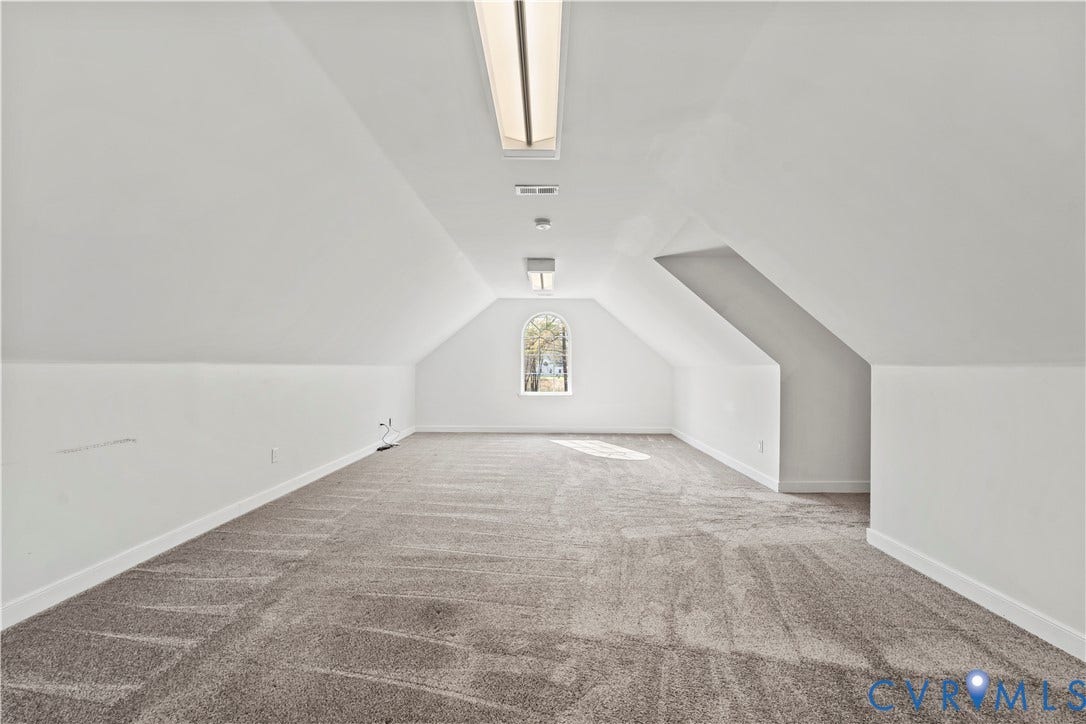 7040 Old Roxbury Road, Average, New Kent, VA 23141 Finished space with arched window, neutral wall-to-wall carpeting, and dual flush-mount ceiling light fixtures