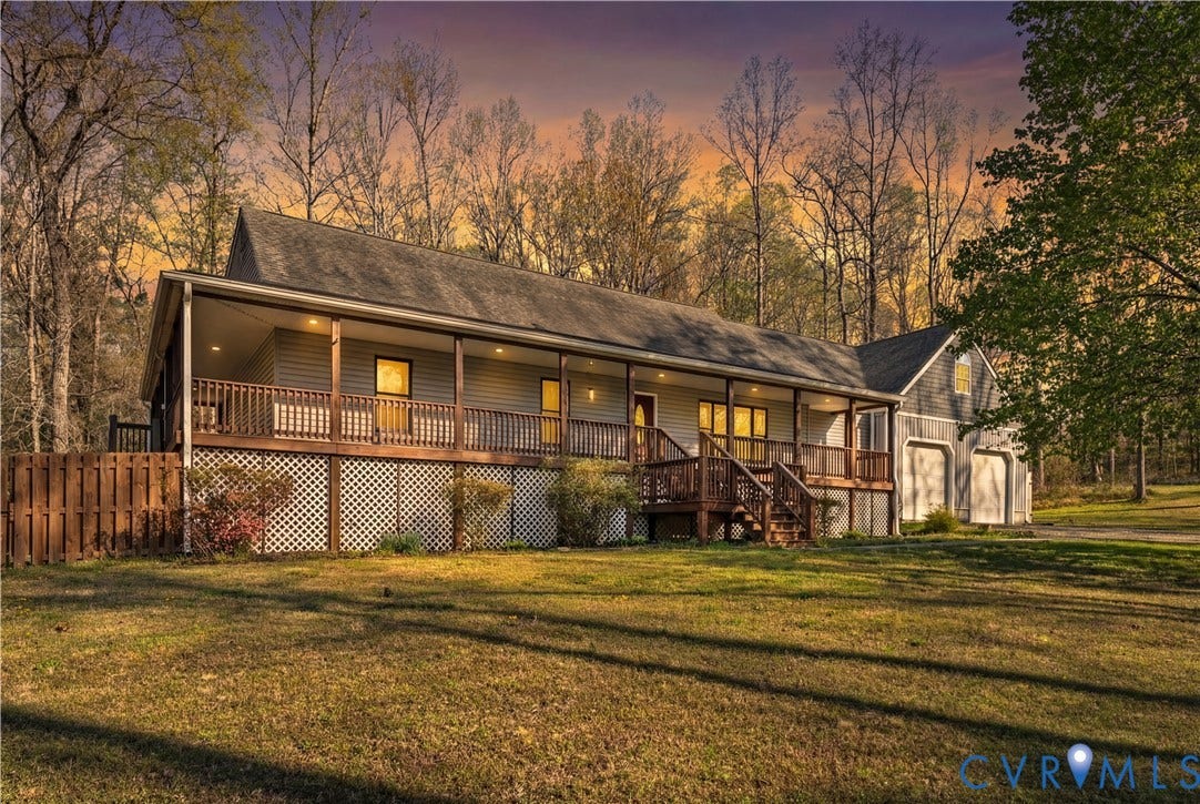 7040 Old Roxbury Road, Average, New Kent, VA 23141 Ranch-style residence featuring a full-length covered porch, attached two-car garage, lattice skirting, and horizontal siding